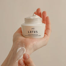 Load image into Gallery viewer, Hand holding lotus probiotic cream jar – microbiome moisturizer for sensitive skin barrier